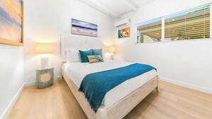 A bedroom with a bed, bedside lamps, a window with blinds, and artwork on the walls. - Walk To Beach and Village W/Jacuzzi & Firepit W/Great Reviews! (San Diego)
