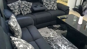 A modern living room with a sectional sofa, a coffee table, and patterned throw pillows. - DraxHall Villa (Saint Ann's Bay)