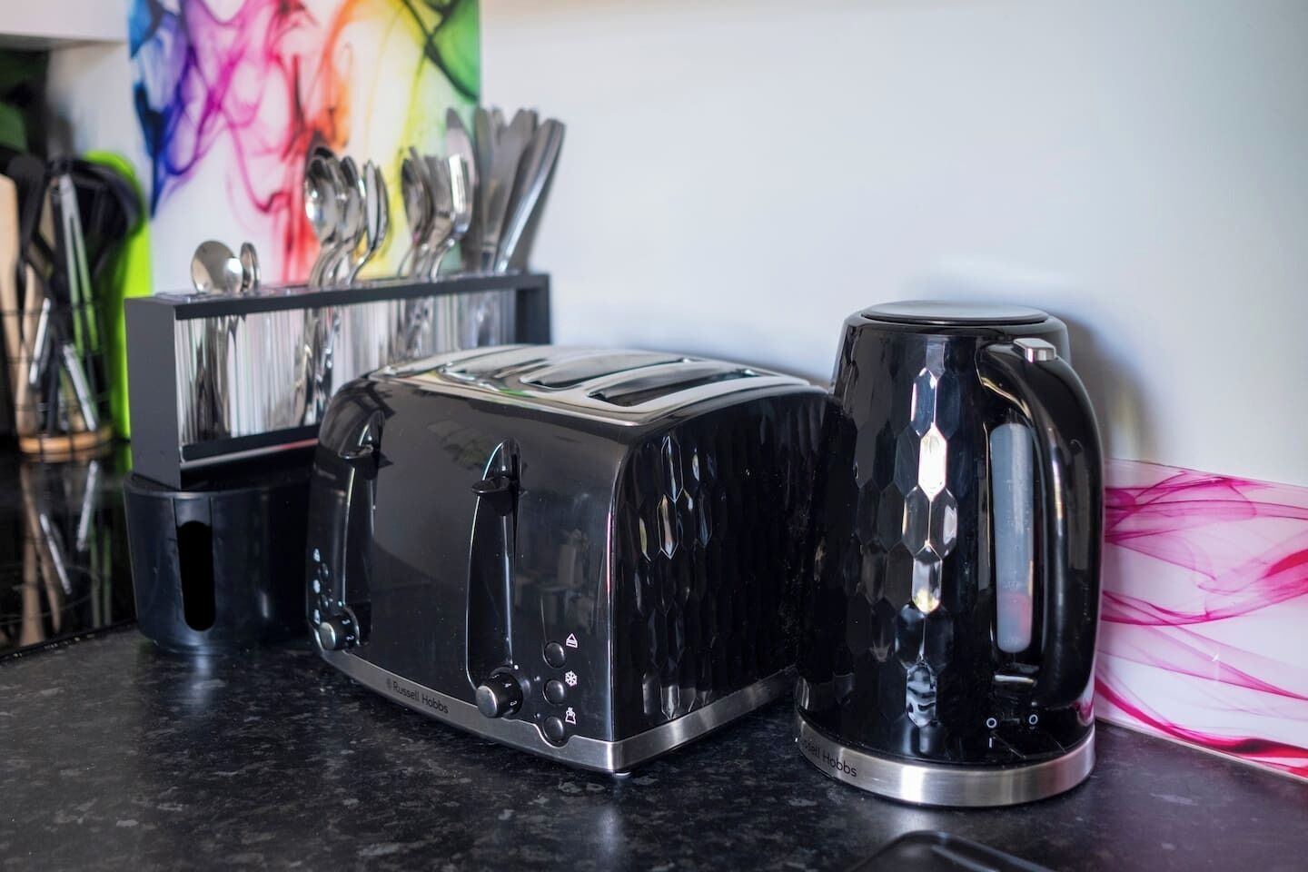 Modern kitchen essentials with sleek toaster, kettle, and stylish design