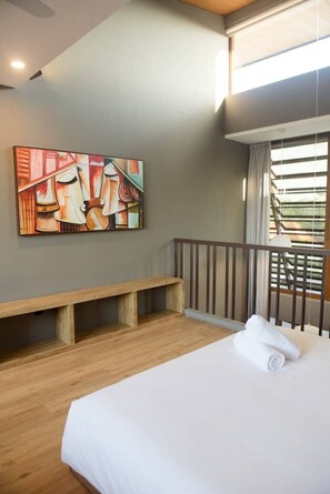 A bedroom with a bed, a bench, a painting, and a window with blinds. - Cozy Mezzanine Loft Bedroom and Master Suite with Shared Pool & Co-Work Deck (badung)