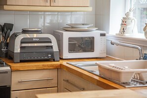 A kitchen with a toaster, microwave, and a sink. - Hudson House (Durham)