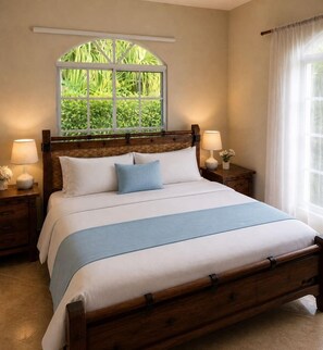 A bedroom with a large bed, wooden headboard, two bedside tables with lamps, a window with a view of greenery, and a curtain on the window. - Fabulous family-friendly 5-bedroom villa with AC in vibrant Sosúa. (Sosúa)