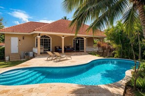 A house with a swimming pool, a covered patio, and a door leading to the interior. - Fabulous family-friendly 5-bedroom villa with AC in vibrant Sosúa. (Sosúa)