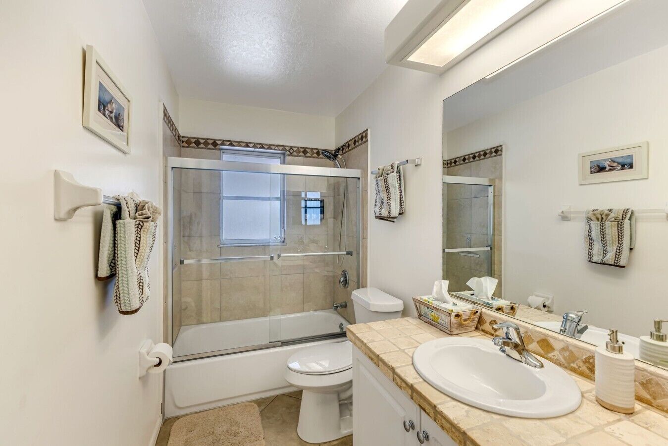 A bathroom with a bathtub, toilet, and sink.