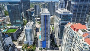 A high-rise urban area with modern architecture, including a prominent building with a blue stripe. - Brickell Bay View Pool & Gym (Miami)