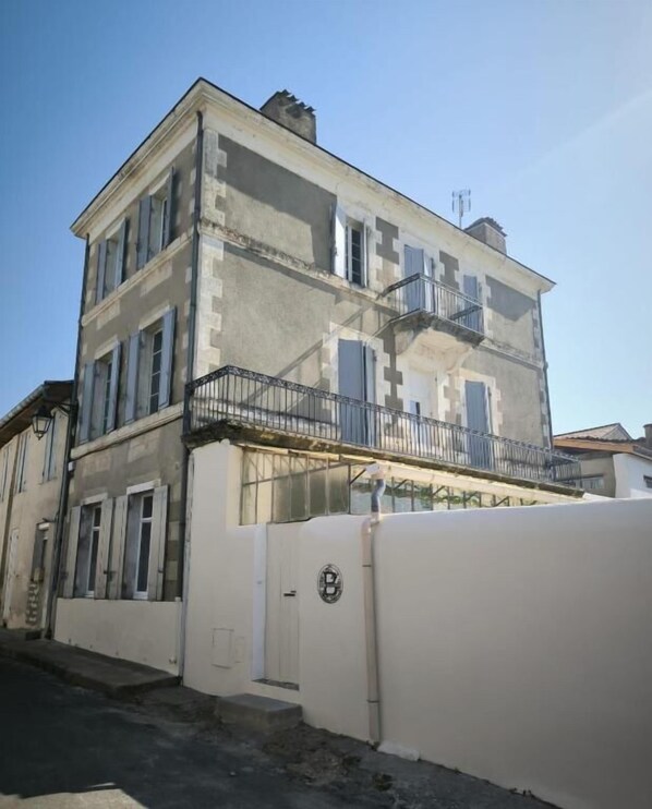 A two-story building with a balcony on the second floor.