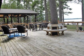 A wooden deck with outdoor seating, a gazebo, and a view of a lake. - Musky Inn North: 5  BR, 3  BA Lodge in St. Germain, Sleeps 10 (St. Germain)