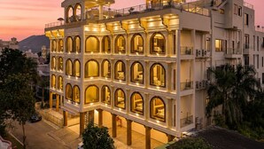 A multi-story hotel with a central courtyard, balconies, and a view of the surrounding area. - Barliyas Heritage Boutique Hotel (Udaipur)