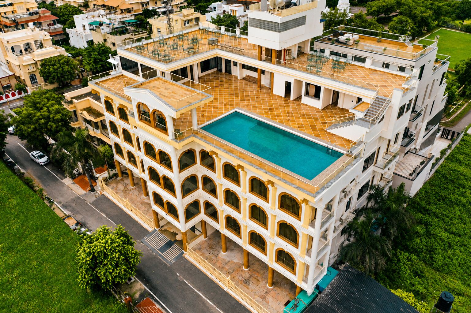 A multi-story building with a rooftop pool and a courtyard.