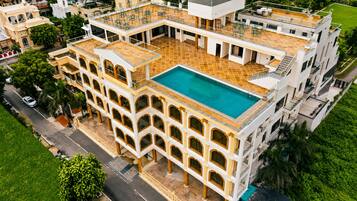 A multi-story building with a rooftop pool and a courtyard.