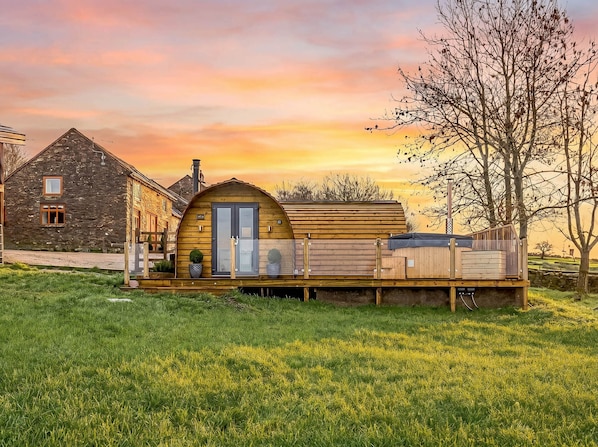 A rustic cabin with a wooden deck, a stone building, and a tree in the background. - The Lodge at Brambles Farm Sleeps 4 Hot Tub (Leek)