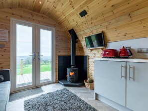 A cozy room with a fireplace, a television, and a kitchenette. - The Lodge at Brambles Farm Sleeps 4 Hot Tub (Leek)