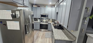 Coffee/tea maker, fridge, microwave, oven