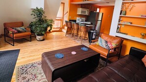 A loft-style living space with a kitchen, dining area, and seating area.