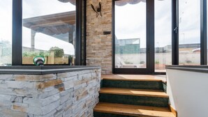A staircase leading to a balcony with stone walls and a view of the cityscape. - Triple G Rooftop 105 By Dimorra  (Naples)