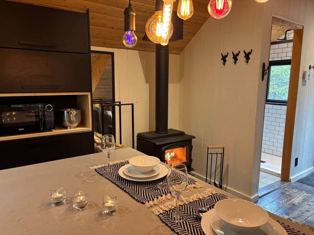A modern kitchen with a central island, a built-in stove, and pendant lighting.