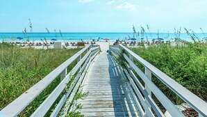 A wooden boardwalk leading to a beach with umbrellas and lounge chairs. - 🏖️Twin Palms 2204 Penthouse~Gulf-Front Views 🌅 Pool~Dedicated Parking (Panama City Beach)