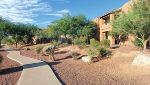 A pathway leading to a building with a desert landscape and trees. - Delightful Resort Near Santa Catalina Mountains! (Oro Valley)