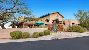 A building with a registration sign, American flags, and a desert landscape. - Delightful Resort Near Santa Catalina Mountains! (Oro Valley)