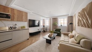 A modern living room with a sofa, a coffee table, and a TV. - The Folio Collection (London)