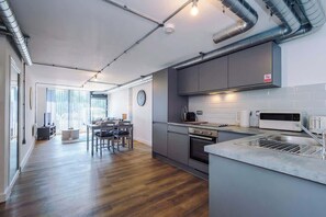 A modern kitchen with stainless steel appliances, a built-in oven, and a microwave.
