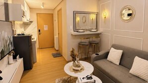 Ein modernes Wohnzimmer mit Sofa, Couchtisch und einer Deckenleuchte.