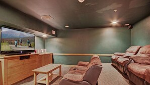 A home theater with a large TV, wooden entertainment unit, and leather recliner seating. - 1 Minute Walk to the Gondola/Shared Pool and Hot Tub/Private Patio (Keystone)