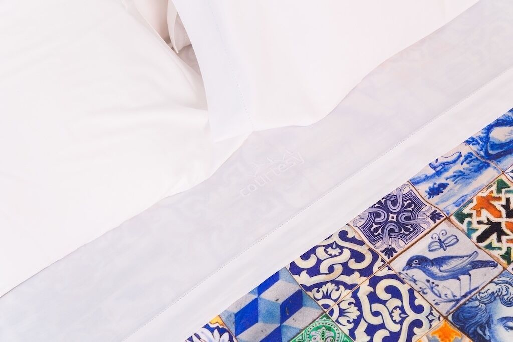 A fabric with a pattern of blue and white tiles.