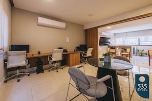 A modern office space with a glass table, swivel chairs, a whiteboard, and a wooden desk. - Caminho das Árvores near the shopping malls (Salvador)