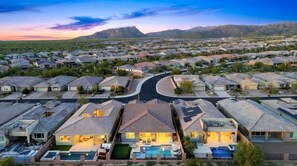 A residential area with houses, a swimming pool, and a road. - Exceptional Desert Escape w/ Pool and Spa (Marana)