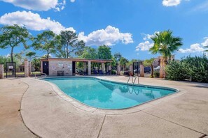 A swimming pool with a covered seating area, surrounded by trees and a clear sky. - Cute Townhome with Community Pool 5 mins to TMC (Tucson)