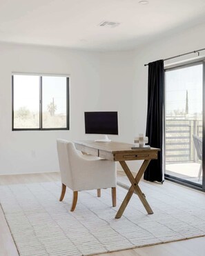 A modern room with a desk, chair, and a large window. - Foothills Upscale Retreat with Heated Pool (Tucson)
