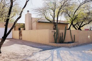 A building with a beige exterior, a number '2936' on the wall, and a cactus in the front. - Midtown Retreat-Pet Friendly (Tucson)