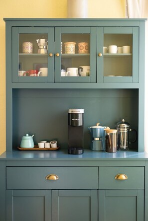 A kitchen with a coffee maker, a kettle, and a French press on the counter. - Midtown Retreat-Pet Friendly (Tucson)
