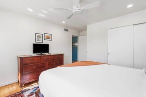A bedroom with a bed, a dresser, a television, and a ceiling fan. - Cactus & Sky Escape with POOL and SPA! (Tucson)