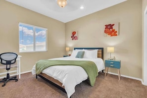 A bedroom with a bed, desk, chair, and two wall-mounted lamps. - Desert Escape- 5 Mins to Starr Pass & Hiking (Tucson)