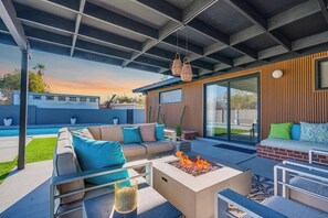 An outdoor patio with a fire pit, seating area, and a view of a swimming pool. - Mid-Century Desert Galore/Mt.Views/Pool (Tucson)