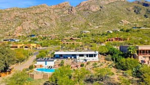 A residential area with houses, a swimming pool, and a mountainous backdrop. - Stunning View w/Heated Pool! (Tucson)