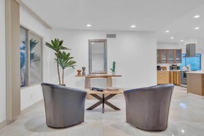 A modern kitchen with wooden cabinets, a built-in oven, and a large window. - Desert Vibes with Pool, Sauna & Game Room! (Tucson)