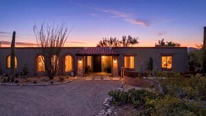 A two-story house with a brick facade, arched windows, and a red-tiled roof. - Catalina Foothills Luxe Retreat with Heated Pool! (Tucson)