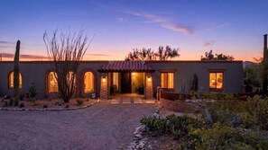 A two-story house with a brick facade, arched windows, and a red-tiled roof. - Catalina Foothills Luxe Retreat with Heated Pool! (Tucson)