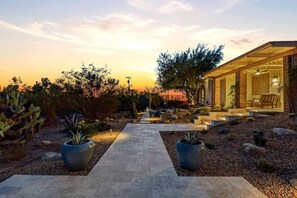 A pathway leading to a building with a covered outdoor area, surrounded by desert vegetation. - Catalina Foothills Luxe Retreat with Heated Pool! (Tucson)