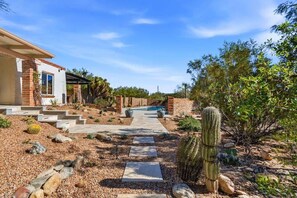 A house with a pool, a cactus, and a pathway leading to the entrance. - Catalina Foothills Luxe Retreat with Heated Pool! (Tucson)