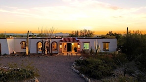 A two-story building with a central entrance, arched doorways, and a patio area. - Catalina Foothills Luxe Retreat with Heated Pool! (Tucson)