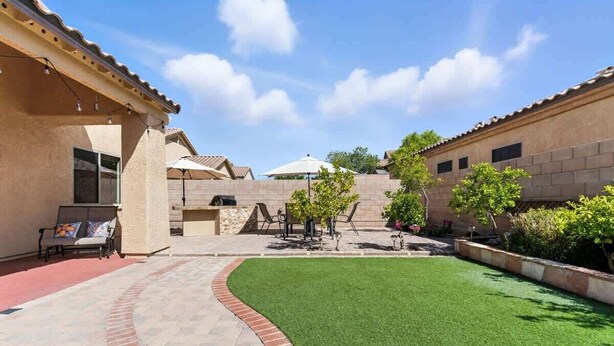 A courtyard with artificial grass, outdoor seating, and a brick pathway. - Desert Solace Retreat w/Pool/Spa (Tucson)