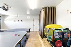A ping pong table, a projector, and a children's play area with inflatable structures. - Desert Solace Retreat w/Pool/Spa (Tucson)