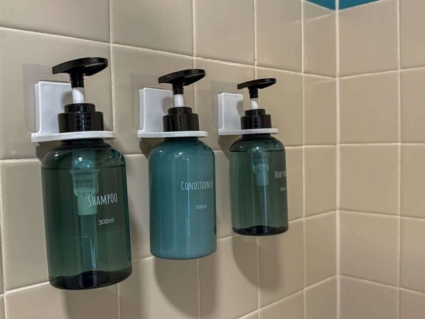 Three bottles of liquid soap on a tiled wall. - Charming Barrio Adobe (Tucson)