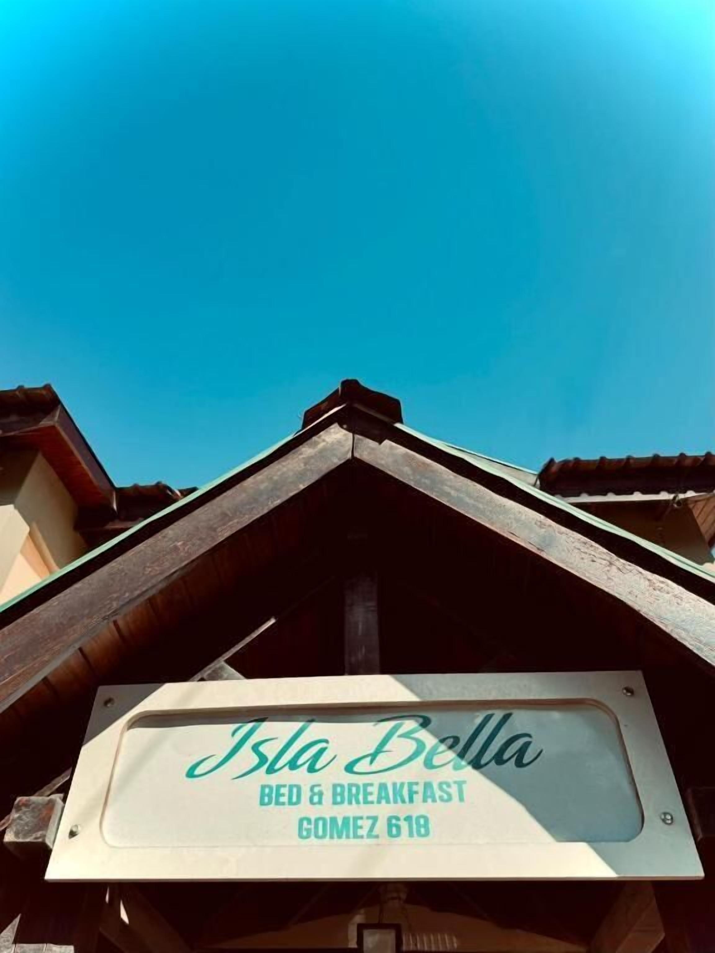 A sign for 'Isla Bella Bed & Breakfast' with a clear view of the sky.