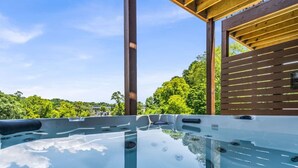 Un bain à remous offrant une vue dégagée sur la végétation environnante et doté d’une structure en bois.