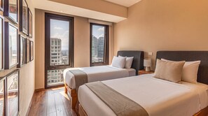A hotel room with two beds, a large window, and a city view. - Miyana by Kukun | 3BR apartment (Ciudad de México)